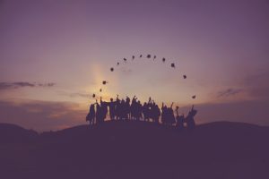 Silhouette of people standing on a hill