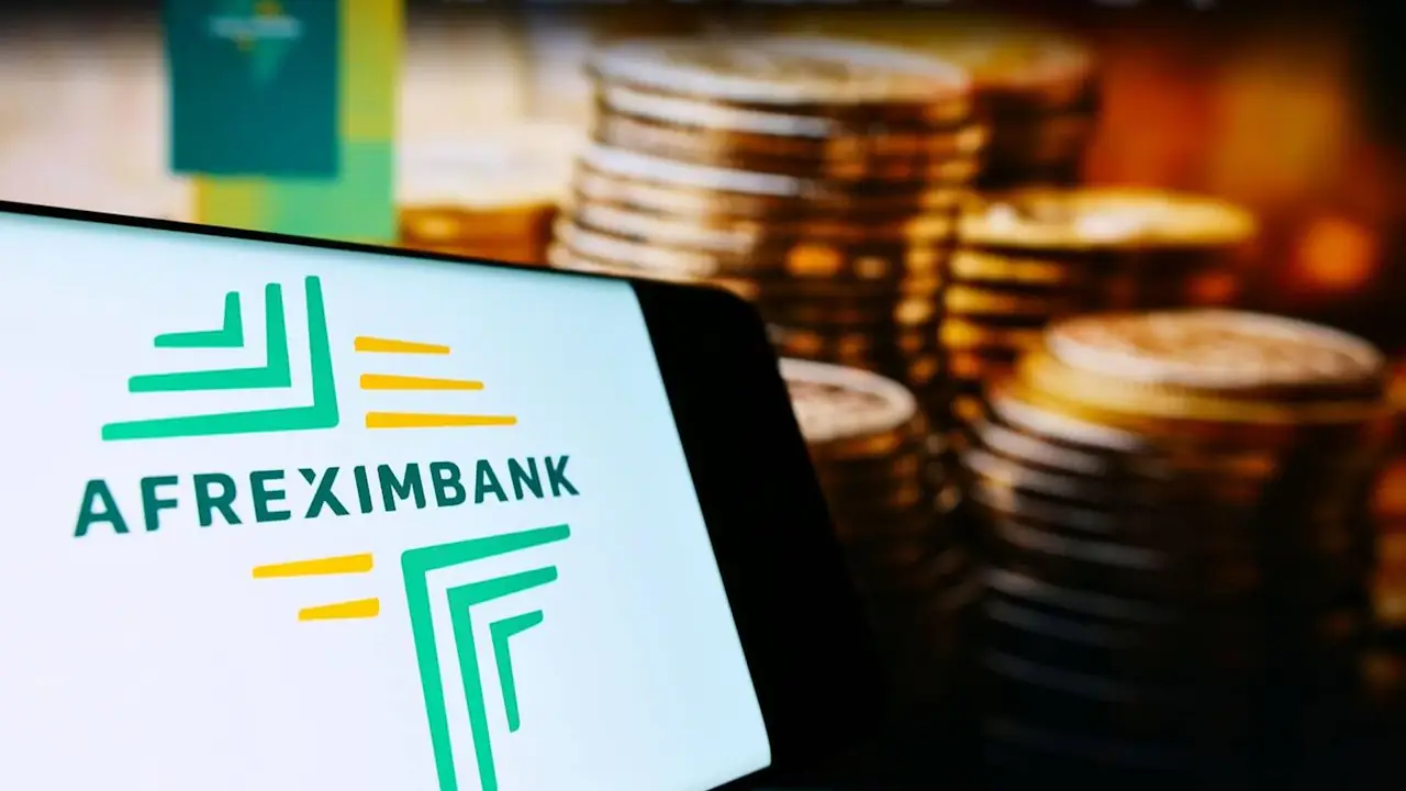 Mobile phone with logo of company African Export–Import Bank (Afreximbank) on screen in front of business website