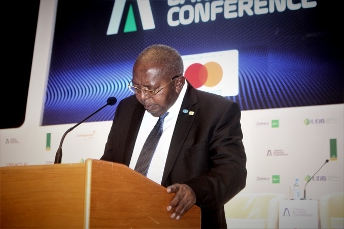 A man at a podium addressing a conference