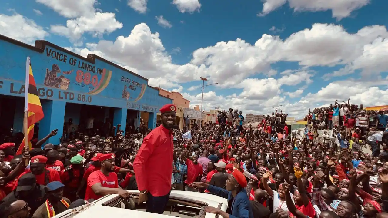 Bobi Wine, standing in a car, surrounded by hundreds of supporters in Lira town, 7 September 2023, while on a countrywide tour.