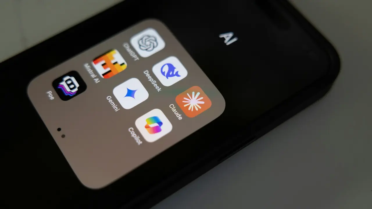 Close-up of a smartphone screen showing a folder labelled "AI" with icons for ChatGPT, DeepSeek, Claude, Copilot, Gemini, Mistral AI, and Poe.