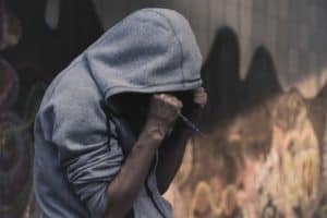 Drug addict holding syringe
