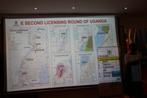 Uganda's minister for energy, Irene Muloni, stands next to a map showing the five oil blocks she had just opened for licensing at the East African Petroleum Conference in Mombasa