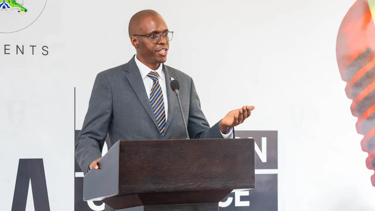 John Tumwine of Stanbic Bank Uganda speaking at a podium at the launch of the Mineral Wealth Conference