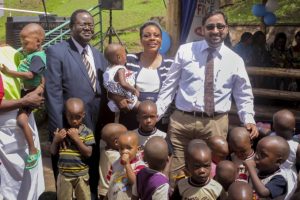 Santosh Gumte, left, the Kansai Plascon Uganda Managing Director, with staff members of Sanyu Babies Home at the handover of proceeds from sales of Plascon's anti-mosquito paint