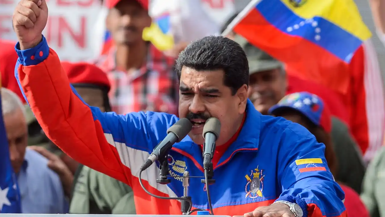 Ousted Venezuelan President Nicolás Maduro gestures with a raised fist while speaking at a rally.