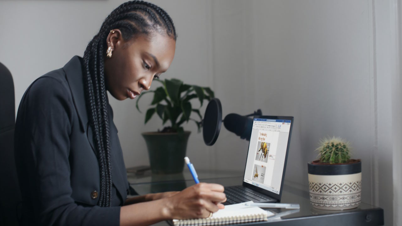 A young woman writing into a notebook