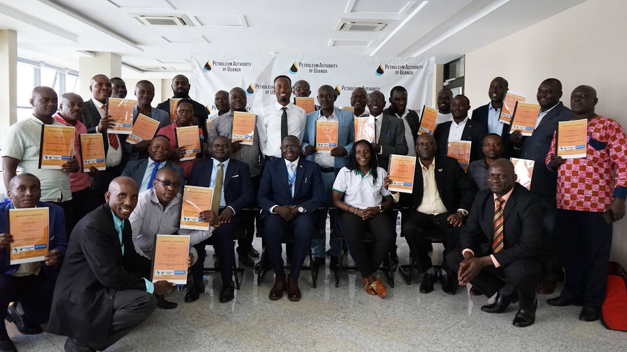 A group photo of people at a signing ceremony.
