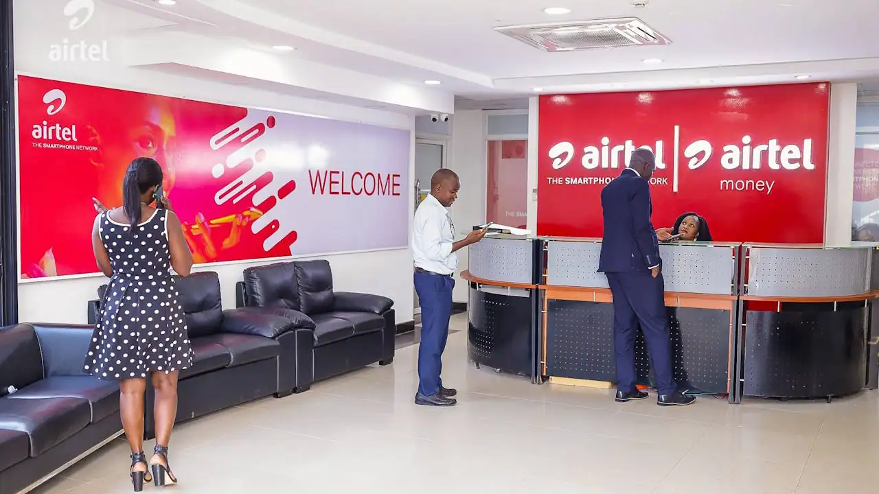 A photo in the reception area of Airtel Uganda's main office on Clement Hill Road in Kampala, and includes four individuals.