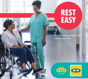 A female nurse talks to a woman in a wheelchair